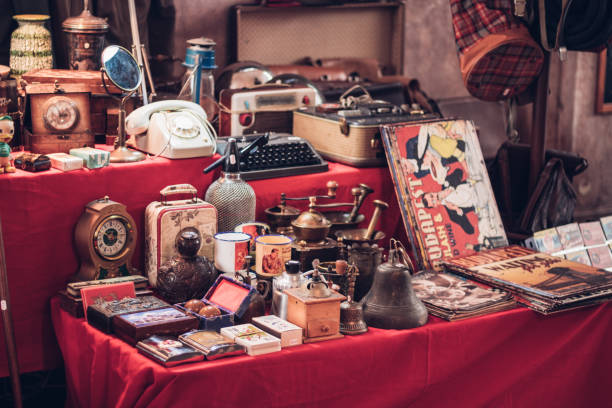 Small group of vintage objects in a flea market Antique watches, magazines, phones, suitcases and other retro products antique stock pictures, royalty-free photos & images