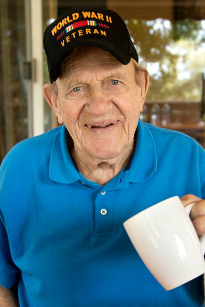 istock World War Two Veteran wearing WW2 cap holding coffee cup 842305312