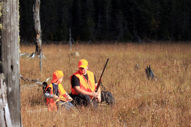 Father and son are hunting Hunters in the autumn forest hunting stock pictures, royalty-free photos & images