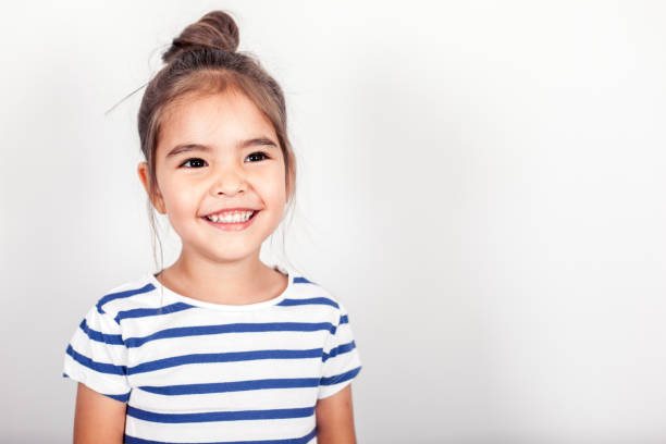 Happy Small Girl Happy small girl on the grey light background in the studio. smiling kids on white stock pictures, royalty-free photos & images