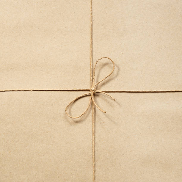 istock Paper rope, knotted at the wrapping paper beige 842318274