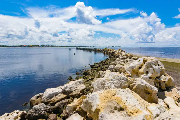 A stone jetty in the Gulf of Mexico protects a harbor entrance.