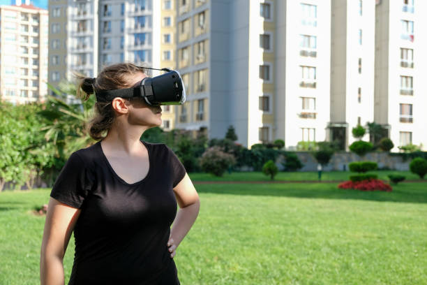 istock Woman with virtual reality goggles at outdoor 842325070