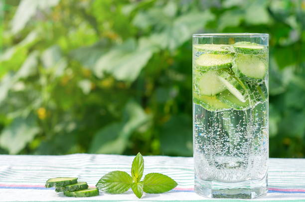 Sliced cucumbers in a glass with mineral water