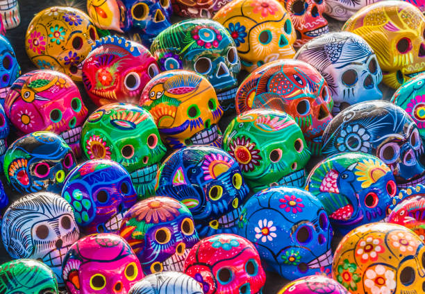 Day of the Dead Skulls Mexican Culture Fiesta: Colorful (colourful) traditional Mexican/hispanic ceramic pottery Day of the Dead (Dia de los Muertos) skulls on display at a market in Mexico. latin music photos stock pictures, royalty-free photos & images
