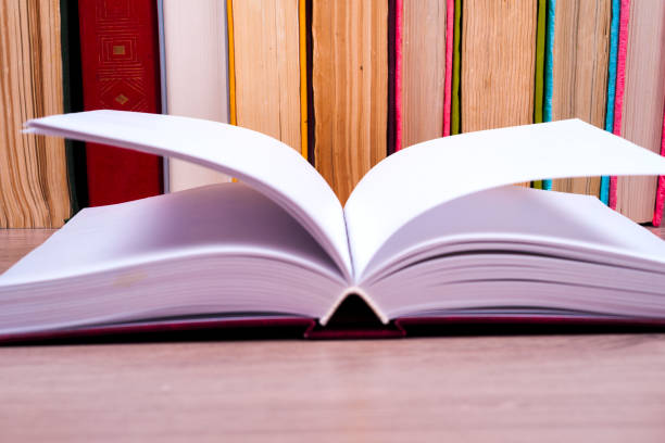 istock Open book, hardback books on bright colorful background. 842330748