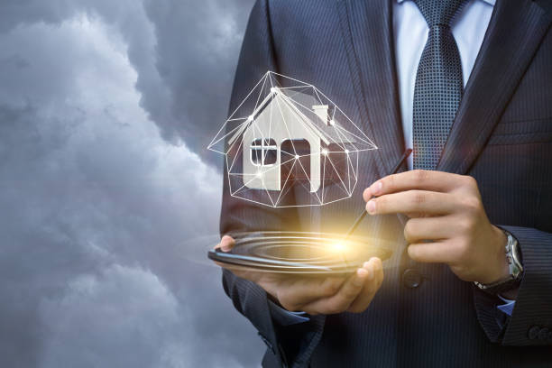 istock Real estate agent holding a model house on the tablet . 842334398