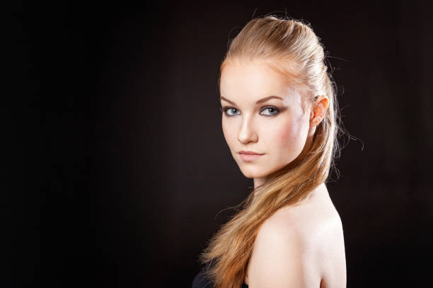 istock Beautiful blonde girl on a black background 842336870