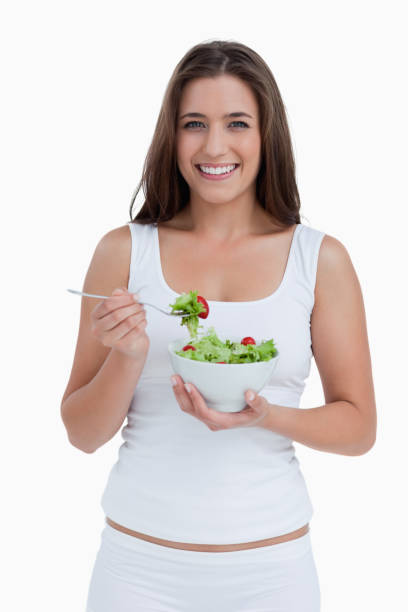 istock Smiling woman eating a salad 842337172