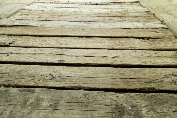 Weathered wooden deck, terrace with algae and moss, spring cleaning in garden and yard