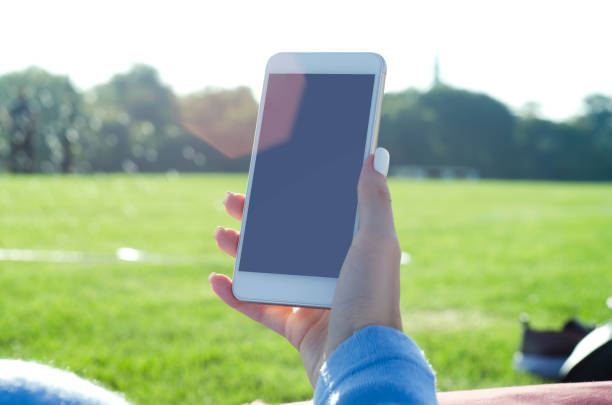 istock Mobile phone in female hand in nature 842340750