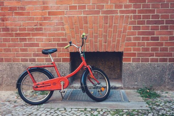 istock red children bicycle on brick wall 842346172