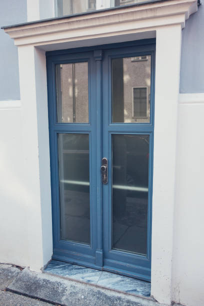 istock blue glass door on white wall 842346764