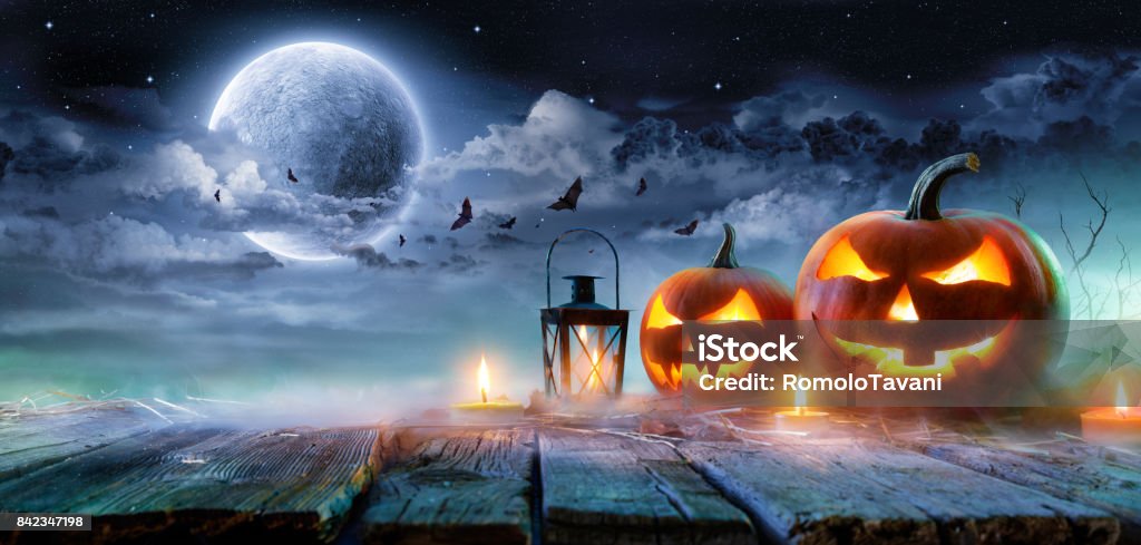 Jack O’ Lanterns Glowing At Moonlight In The Spooky Night - Halloween Scene HalloweenPumpkins Burning Haunted Nigh Pumpkin Stock Photo