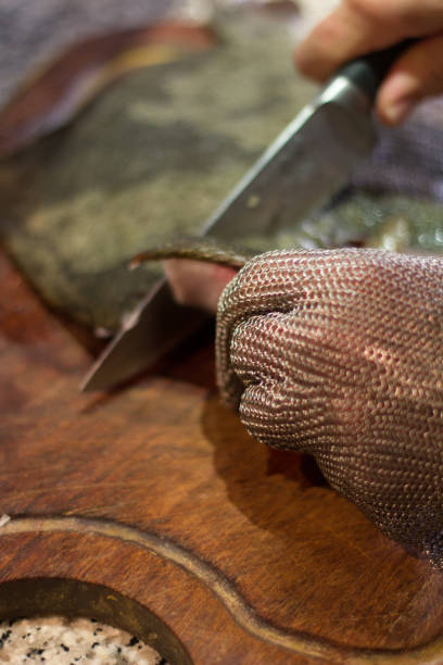 istock Filleting a fish with Chain mail gloves 842350624