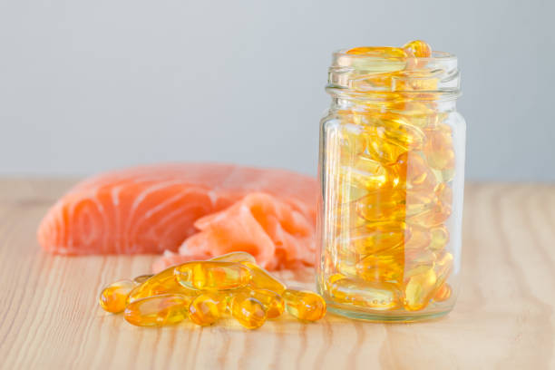 istock Pure omega salmon oil capsul and salmon. 842363510