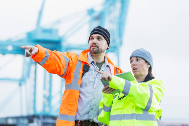 istock Man and woman working at shipping port 842363586