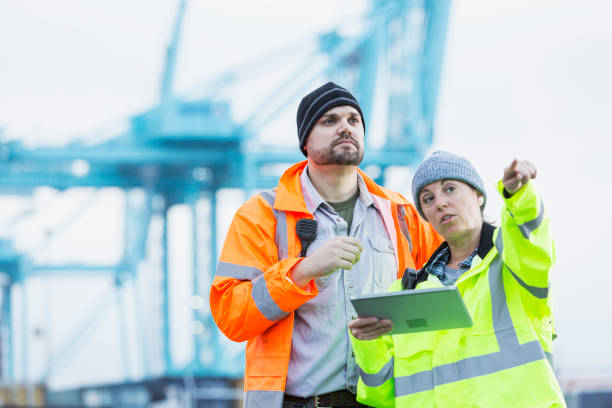 istock Man and woman working at shipping port 842363592