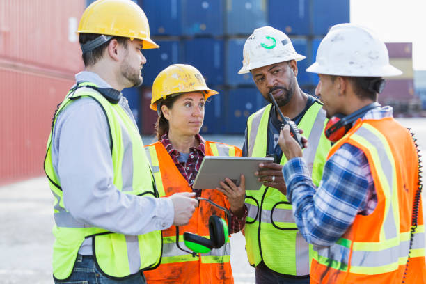 istock Multi-ethnic workers at shipping port, woman in charge 842366098