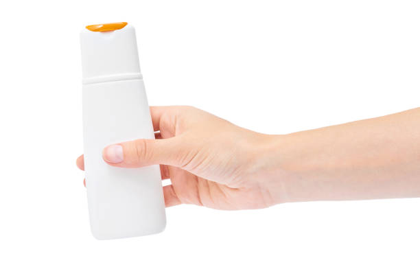 istock Hand holding shampoo bottle isolated on white background 842369596