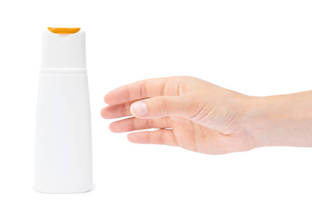 istock Hand holding shampoo bottle isolated on white background 842369604