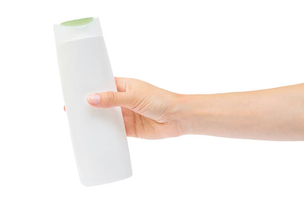 istock Hand holding shampoo bottle isolated on white background 842369616