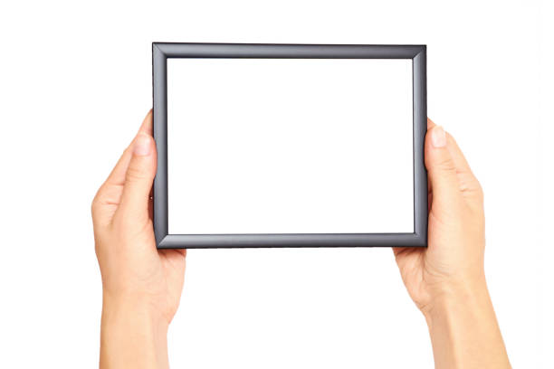 Decorative black photo frame in hand isolated on white background Decorative black photo frame in hand isolated on white background. old black leather photo album stock pictures, royalty-free photos & images
