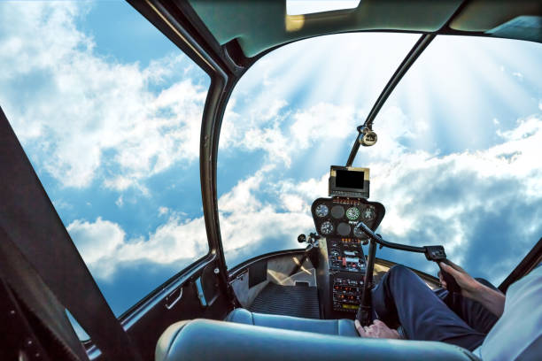 Cockpit in cloudy sky Helicopter cockpit flies in San Francisco Financial District Downtown, California, United States, with pilot arm and control board inside the cabin.Helicopter cockpit in a cloudy blue sky ad day. flight instruments stock pictures, royalty-free photos & images