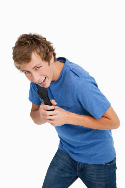 istock Portrait of a young man singing with a microphone 842373768