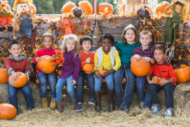 istock Multi-ethnic children with pumpkins at fall festival 842373988