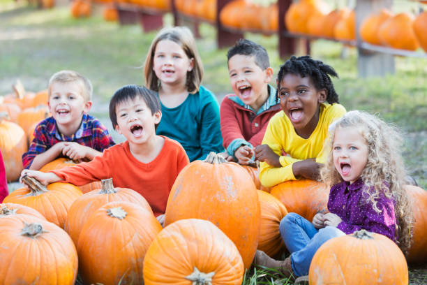 istock Multi-ethnic children at pumpkin stand 842374016