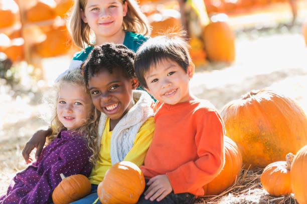 istock Multi-ethnic group of children at pumpkin stand 842374066