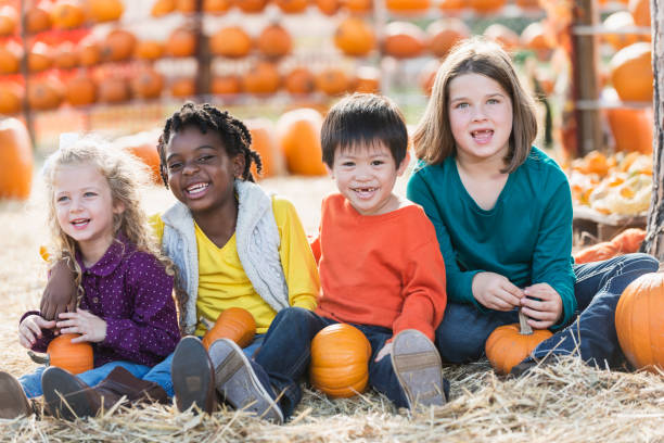 istock Multi-ethnic group of children at pumpkin stand 842374102