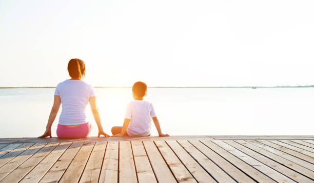 istock Mother with her son enjoying lake view 842376288