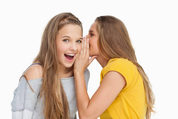 istock Blonde student whispering to her friend 842376518