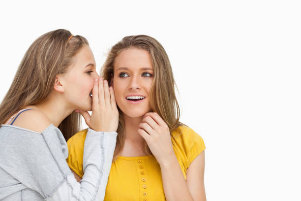 istock Blonde student whispering to her beautiful friend 842376522