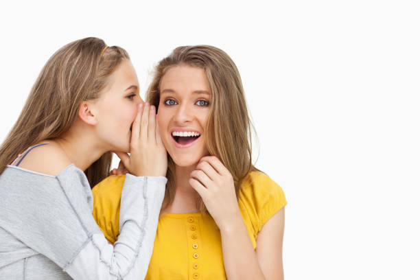 istock Blonde student whispering to a friend 842376532