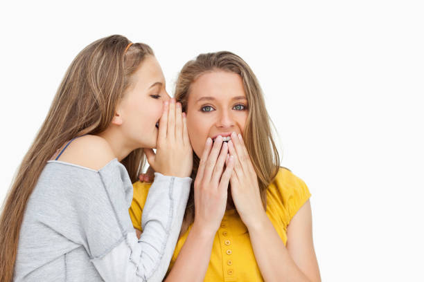 istock Blonde student whispering to her voiceless friend 842376544