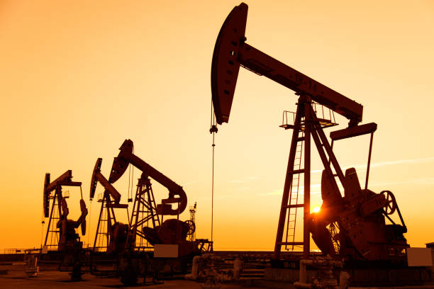 istock Oil pumps and rig at sunset 842376856