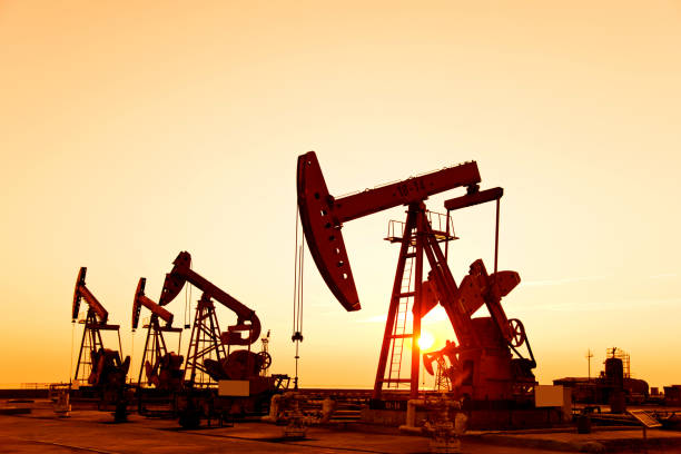 istock Oil pumps and rig at sunset 842376872