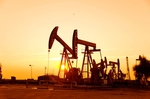 istock Oil pumps and rig at sunset 842376904