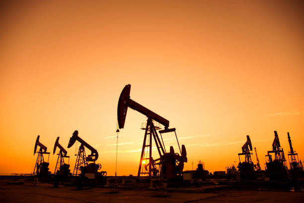 istock Oil pumps and rig at sunset 842376924