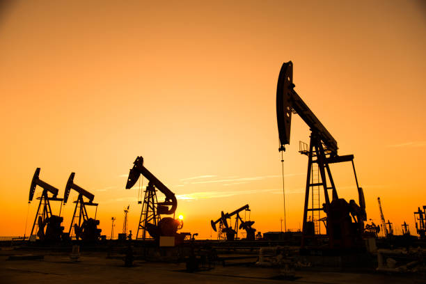 istock Oil pumps and rig at sunset 842376962