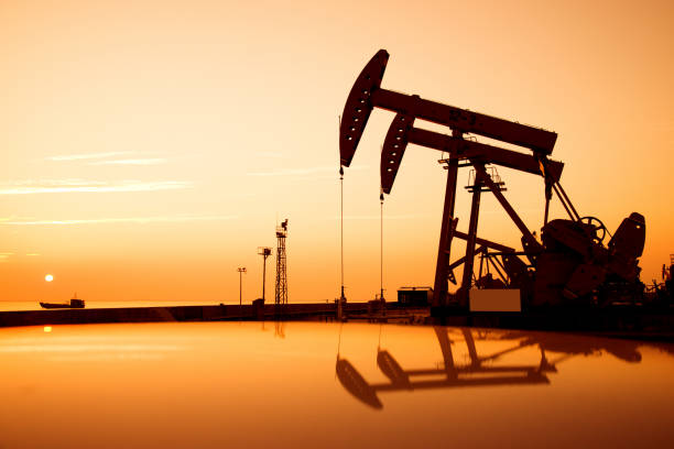istock Oil pumps and rig at sunset 842376980