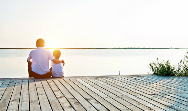 istock Father with his son enjoying lake view 842379122