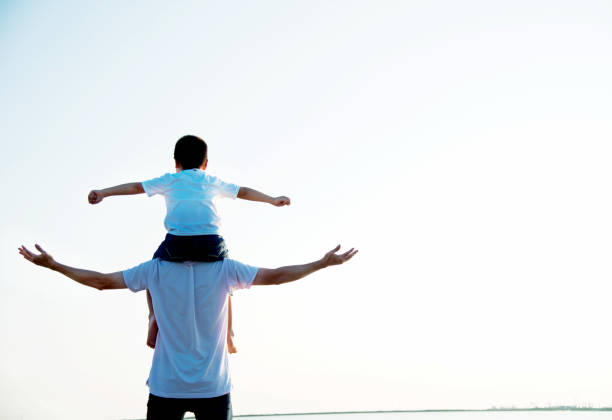 istock Father carrying his son on shoulders 842379136