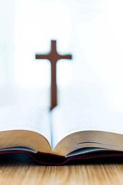 istock Bible and cross on desk 842379510