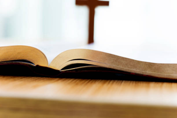 istock Bible and cross on desk 842379562