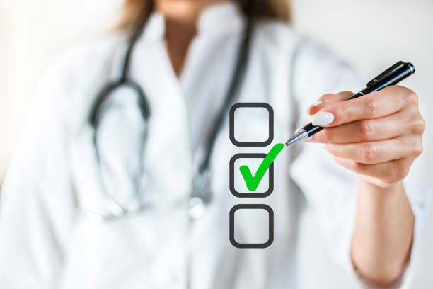 Doctor hand checking the checklist boxes in air