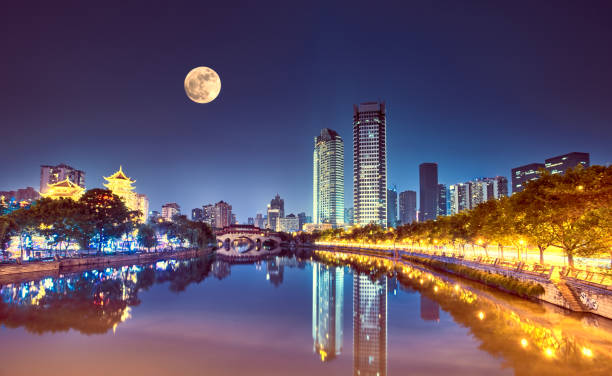 The Anshun Bridge crosses the Jin River with the moon in the sky, Chengdu, China. Landmark of  Chengdu, Sichuan province of China. chengdu photos stock pictures, royalty-free photos & images